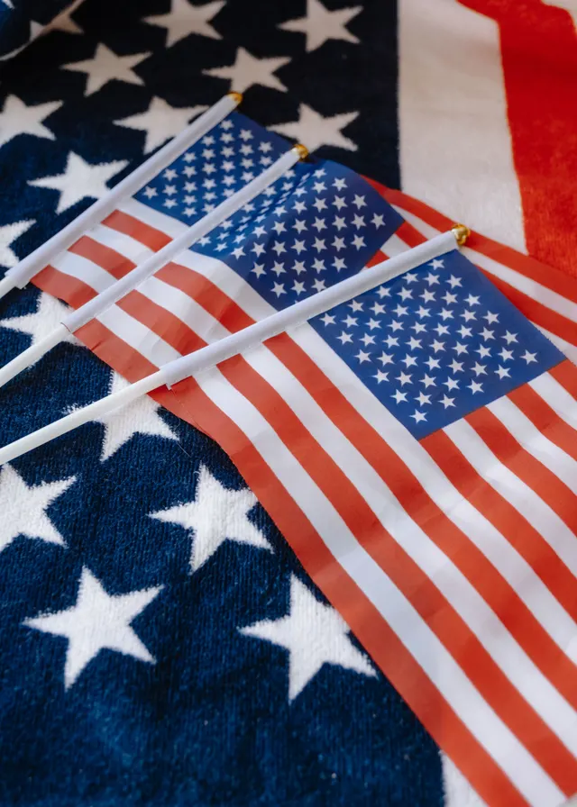 Small American flags resting on a stars-and-stripes blanket